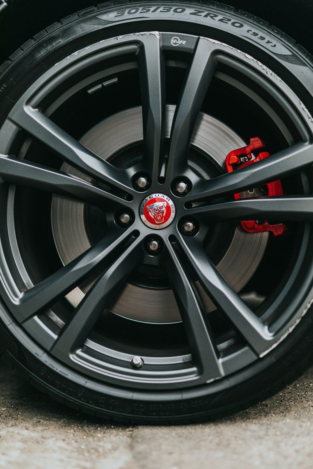 Close view of a matte black alloy wheel and tire